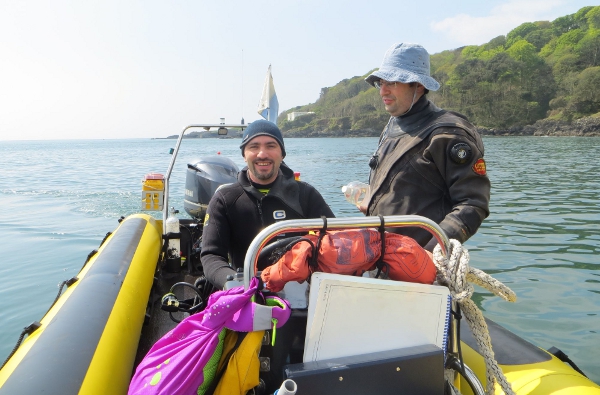 Murat driving boat under supervision of Ben
