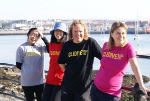 Four people wearing Clidive T-shirts